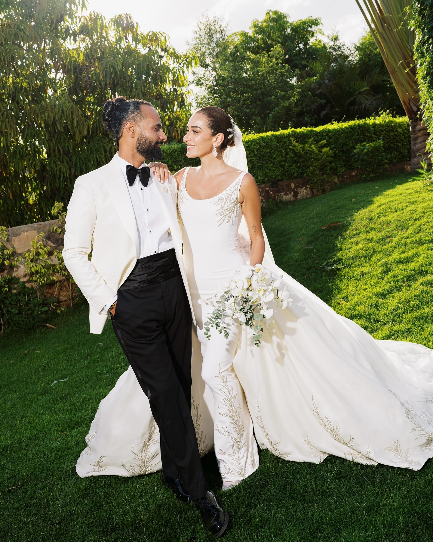 On the most important day of her life, #AminaKhalil stepped into her forever, surrounded by towering palms and a sea of white. For this deeply personal celebration, she wears a custom creation by Maison Yeya: a modern interpretation of a timeless princess silhouette. Designed by Yasmine Yeya, the gown sculpted her figure before cascading into voluminous layers of triple silk gazar, delicately embroidered at the hem. Captured exclusively for Vogue Arabia, the first glimpse of an Egyptian actress revealing a modern bridal vision.
في أهم يومٍ في حياتها، أطلت أمينة خليل كحلمٍ محاطةً بسحر النخيل الباسق ونقاء الأبيض الناصع. لحفلها زفافها، تألقت أمينة بفستان من "ميزون يحيى"، صُمم خصيصًا ليجعل منها أميرةً عصريةً خالدة. احتضن الفستان، الذي أبدعت ياسمين يحيى بتصميمه، قوامها قبل أن يتدفق على طبقاتٍ شاسعة من الغازار الحريري، مطرزًا بدقةٍ عند الأطراف. وفي صورٍ حصرية لمجلة ڤوغ العربية، تلوح أول لمحةٍ لممثلةٍ مصريةٍ تكشف رؤيةٍ عصريةٍ لفساتين الزفاف.
Photography: @lamismagdy
Stylist: @mohamedashraff
Makeup: @Itsnohathemua
Hair: @kimisafadi
Dress: @maisonyeya
Shoes: @jimmychoo
Jewellery: @elkadyjewelry
Event planning: @vertex.events
#VogueArabia