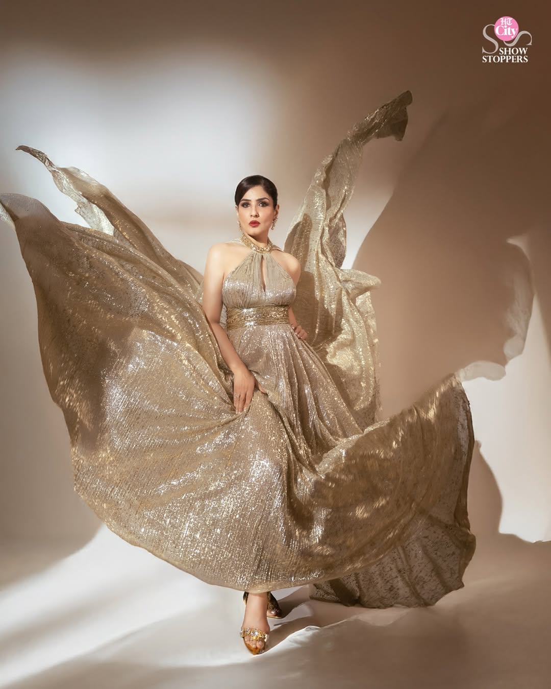 Raveena Tandon (@officialraveenatandon) effortlessly blends classic charm with contemporary flair. Her fashion sense is all about elegance with a bold twist—never afraid to experiment, yet always staying true to herself. The actor shares, “If you are aware of what’s going on, how the world is changing around you, and you just go with the flow, the fashion relevance would probably come naturally, because you will wear what is going on around you.”
Shimmering in gold, Raveena wears this dress with a halter-neckline, by Suneet Varma (@suneetvarmaofficial). The bodice of the dress is adorned with intricate sequins and a waist belt. Finally, the long train of the dress adds to visual drama of the look, giving her a luxurious and eye-catching appearance. Her look is further enhanced with a pair of diamond earrings in gold from Shailja’s Fine Jewellery (@shailjas_fine_jewellery).
Suneet Varma and Shailja’s Fine Jewellery will also be part of the FDCI (@fdciofficial) Manifest Wedding Weekend taking place on 2 and 3 August 2025 at Taj Palace in New Delhi.
Creative Direction: Sameer Katariya (@sameerkatariya92)
Photographer: Deepak Das (@deepak_das_photography)
Styling Coordination: Richa Ranawat (@richaranawat)
Styling Assistant: Sameera Shaikh (@sam_shaikh_167)
Makeup: Isha Singh (@isha__mua)
Hair: Ashis Bogi (@ashisbogi)
Production: Zahera Kayanat (@kayanaaaaat)
Talent Co-ordinator: Kavita Awasthi (@kavita600)
Location: The Lalit Mumbai (@thelalitmumbai)
#raveena #raveenatandon #raveenatandonfans #diva #fashion #fashiongame #fashionista #cover #covershoot #timeless #glam